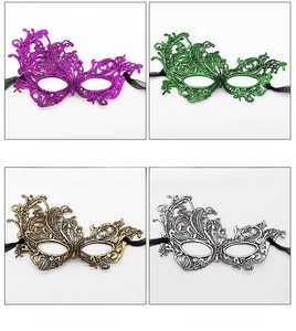 Detail view of four gilded lace masks in purple, green, gold, and silver colors