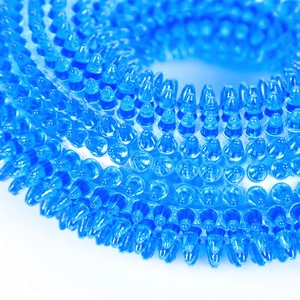 Macro view of blue TPR dog ring toy featuring dense massage spikes and flexible texture