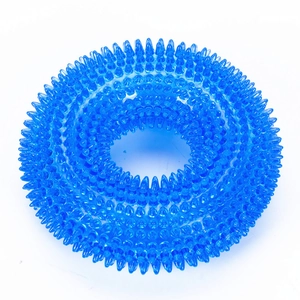 Macro shot of blue translucent spiky TPR ring toy for large dogs showing teeth cleaning texture
