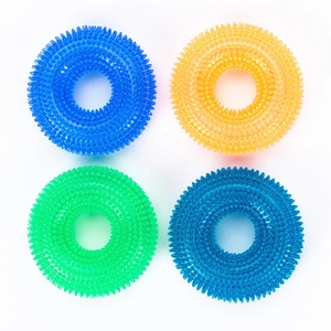 Detailed close-up of colorful spiked TPR dog chew rings in blue, yellow and green
