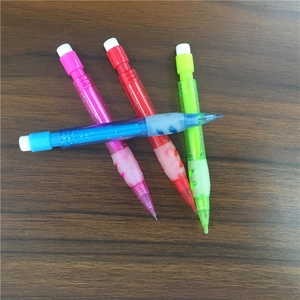 Close-up of four colorful 0.7mm mechanical pencils with rubber grips on wood