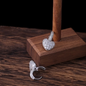 Elegant heart-shaped silver earrings with micro-pave white zircon on wooden display
