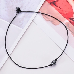 Minimalist black leather cord necklace featuring dual dark grey pearls and handcrafted knots