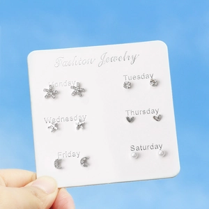 Detail of 6-pair silver stud earring set with stars, hearts and pearls on card