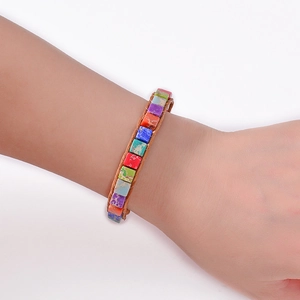 Macro detail of rainbow jasper square beads hand-woven into a bohemian yoga bracelet