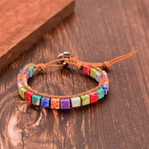 Detail of bohemian wrap bracelet with square colorful natural stones and leather cord