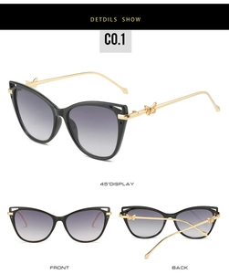 Detail view of cat eye sunglasses with gold butterfly hinges and gradient lenses
