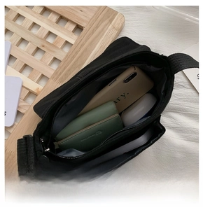 Interior view showing the large storage capacity of the black canvas crossbody bag