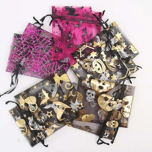 Detail of Halloween drawstring organza gift bags with gold skull and bat patterns