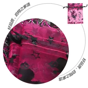 Detail of pink organza Halloween gift bag with black bat and star foil patterns