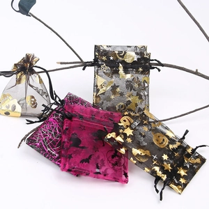 Detailed view of Halloween organza gift bags with gold foil bats and ghost patterns