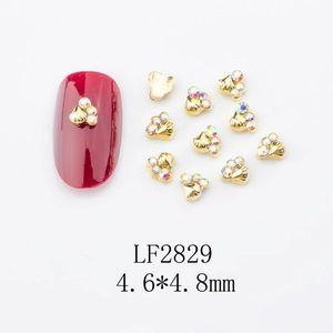 Golden shell nail art charms with iridescent rhinestones and 4.6x4.8mm display on red tip