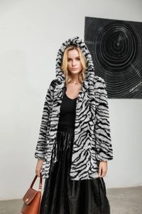 Detailed texture of zebra print faux fur coat with warm hooded design and soft finish