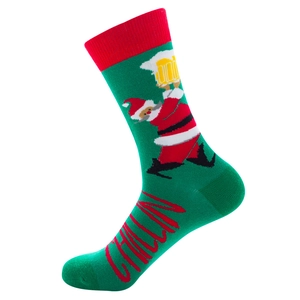 Detail of green Christmas sock with Santa holding beer and red Chillin text on the foot