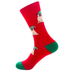 Detail of red Christmas crew sock featuring pug dogs in green hats and cotton texture