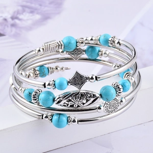 Multi-layer wrap bracelet featuring natural turquoise beads and vintage silver hardware
