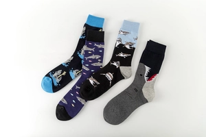Detailed flat lay of four colorful shark pattern cotton crew socks for men in assorted styles