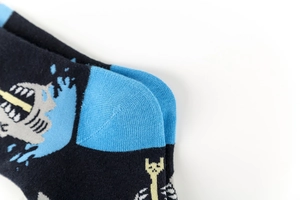 Macro detail of shark and skull patterns on colorful cotton mid-tube socks heel and cuff