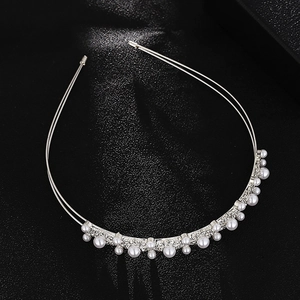 Detail of silver double-layered headband featuring glossy pearls and sparkling rhinestones