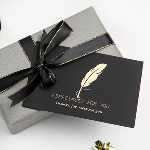 Gray textured gift box with black ribbon and gold foil card saying Especially For You