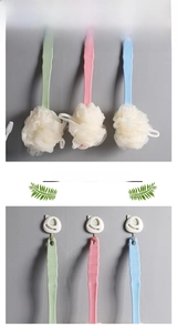 Detail of long handle bath brush with dense mesh loofah and wavy non-slip grip