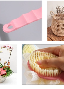 Detail of pink long handle bath brush with soft bristles and non-slip ergonomic grip