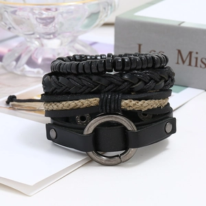 Detail of four-piece black leather punk bracelets with metal ring and wooden beads