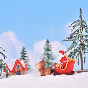 Miniature Christmas landscape set with Santa sleigh reindeer and snowy pine trees