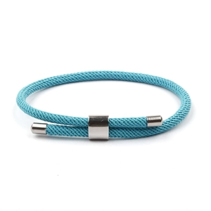 Macro detail of sky blue braided Milan rope bracelet with adjustable steel slider