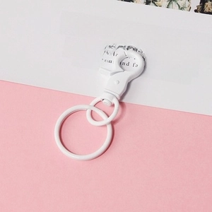 Close-up of white painted metal lobster clasp and round key ring for DIY accessories