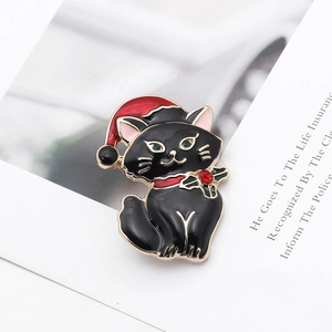 Detail of Christmas black cat brooch with red Santa hat and festive enamel finish