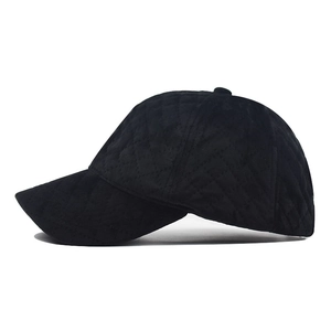Side view of black quilted baseball cap featuring diamond stitching and curved brim