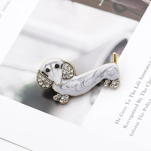 Detail of dachshund dog brooch with grey enamel finish and white sparkling rhinestones
