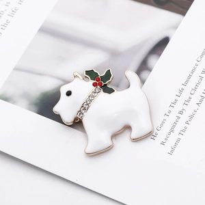 Detail of a white enamel Scottie dog brooch with a festive rhinestone berry collar