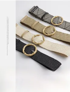 Detail of woven straw belts with round bamboo buckles in black, beige, and khaki colors