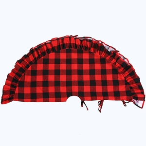 Detail of red and black buffalo plaid Christmas tree skirt with ruffled hem border