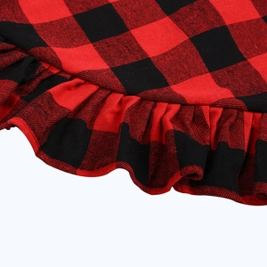 Detail of red and black buffalo plaid Christmas tree skirt with ruffled edges