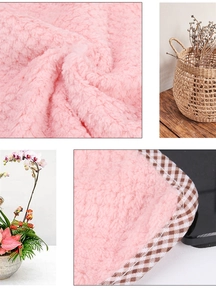 Detail of pink pineapple texture microfiber towel with brown checkered piping edge