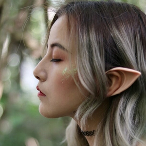 Cosplay elf ears props in flesh tone shown on a model for Halloween party events