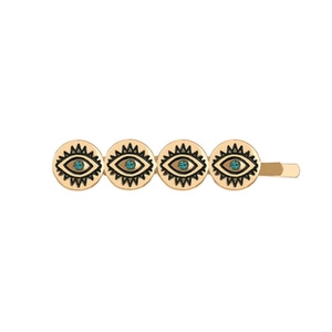 Detailed view of golden snake hair clip with blue evil eye motifs and polished metal finish