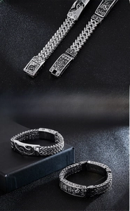 Macro detail of men's stainless steel bracelets with mechanical relief and braided chain
