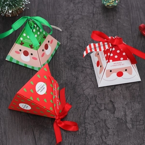 Three pyramid Christmas gift boxes with Santa patterns and ribbons on dark wood background
