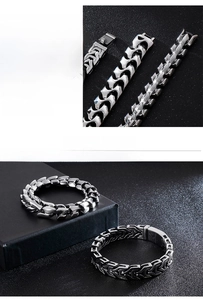 Macro detail of men's stainless steel dragon bone link bracelet with hidden clasp