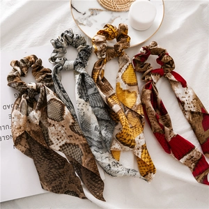 Set of four snakeskin pattern hair scrunchies with long ribbons in four various colors