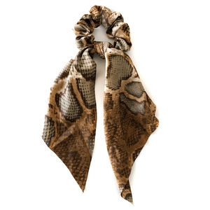 Brown and grey snake print silk scrunchie with elegant long ribbons on white background