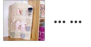 Detail of hanging storage organizer with clear pockets for socks in a wooden wardrobe