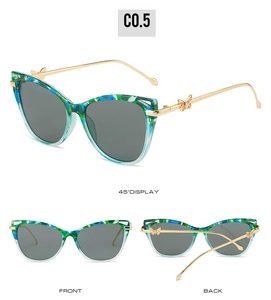 Detail of cat eye sunglasses with camouflage frame and gold butterfly metal temple joints