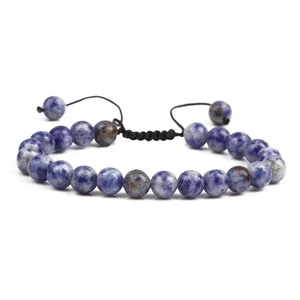 Macro view of blue natural stone beaded bracelet with adjustable braided rope closure