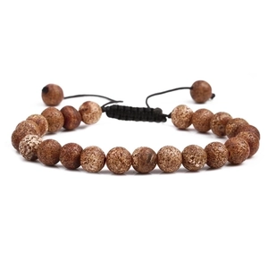Detailed view of handmade braided tiger eye and natural stone beads with adjustable cord