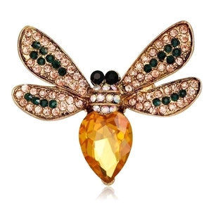Detail of bee brooch featuring gold plating and waterdrop-shaped brown crystal